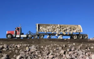 SmithCo Side Dump Trailer Dumping Rocks Sold by TransWorld Equipment